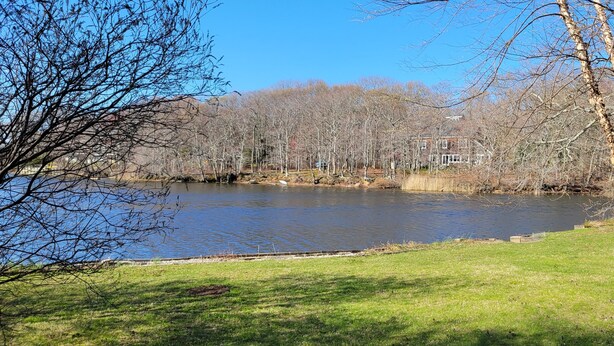 A lake with trees and a building in the background. - Lake House Located Near North Fork Wineries (Southold)