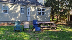 A house with a front porch, a wooden table, and two chairs. - Lake House Located Near North Fork Wineries (Southold)