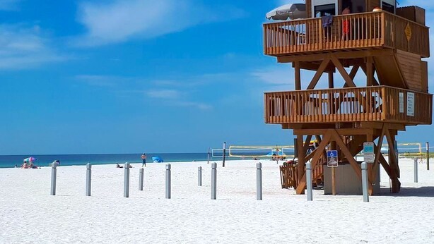 A wooden lifeguard tower with a balcony, located on a sandy beach with clear skies. - *Casa Mia* Fabulous 2BR Condo w/2Pools, Mins to IMG/Beach/Anna Maria Isl (Bradenton)