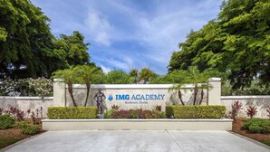 The entrance to IMG Academy in Bradenton, Florida, featuring a landscaped area with trees and shrubs. - *Casa Mia* Fabulous 2BR Condo w/2Pools, Mins to IMG/Beach/Anna Maria Isl (Bradenton)