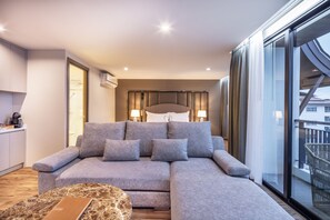 Deluxe Double Room | Living area | 55-inch flat-screen TV with cable channels, TV