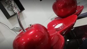 A red object with a reflective surface, possibly a piece of furniture or equipment. - Departamentos Arequipa Inn (Arequipa)