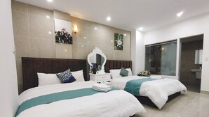 Habitación de hotel con dos camas, un espejo grande y zona de ducha.