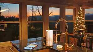 A kitchen with a modern faucet, a toilet paper roll, and a Christmas tree. - NEW RATES! HEAVENLY Views. 150+ 10 out of 10 Reviews! 5 mins to downtown Gburg. (Gatlinburg)
