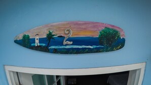 A wall with a painted seascape, a lighthouse, and the number 2. - Casa Piña Apartment 2 (Rincon)