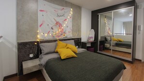 A bedroom with a bed, a nightstand, a mirror, and a wall-mounted tapestry. - I City Theme Park Lux Home_link to mall_near UITM SCCC (I-City)
