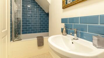 Combined shower/bathtub, hair dryer, towels, soap