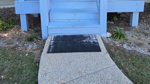 A front porch with a white door marked "1144" and a welcome mat. - 2/2 condo daphne Al. (Daphne)