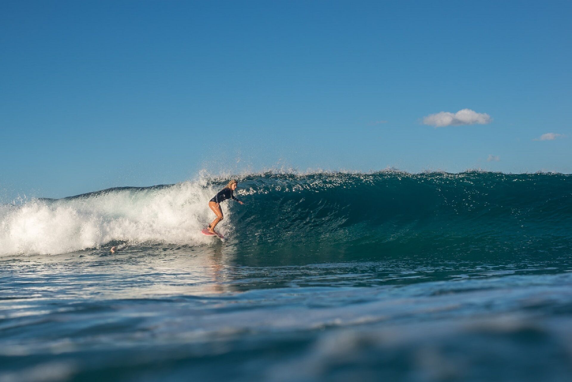 A surfer riding a large wave.