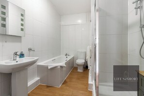 Bathtub, hair dryer, towels, soap