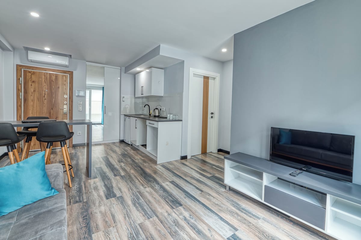 Un appartement moderne comprenant un coin repas, une cuisine et un salon.