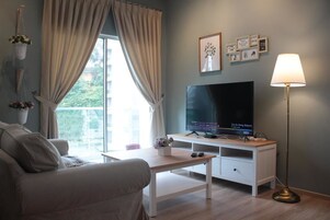 Family Apartment, 3 Bedrooms | Living room | 127-cm Smart TV with satellite channels, TV