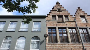 Two buildings with distinct architectural styles, one with a modern facade and the other with traditional brickwork and dormer windows. - Citystay (Antwerp)