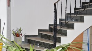 A staircase with a black railing and marble steps. - A holiday house / apartment with a difference - with a sauna in the living area.  (Löbnitz)