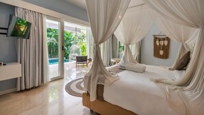 A bedroom with a canopy bed, a TV mounted on the wall, and a view of the outdoors.