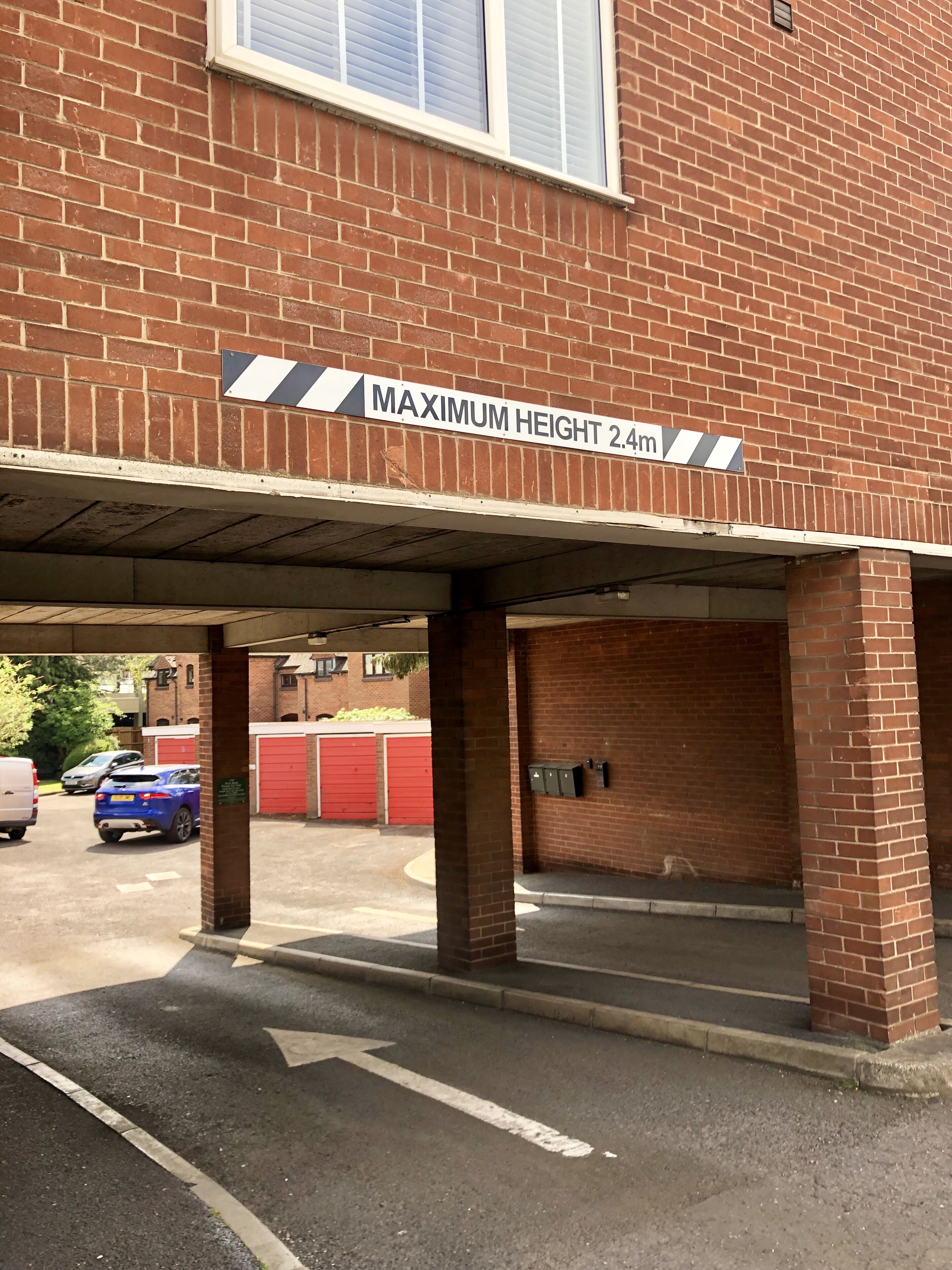 A parking garage entrance with a maximum height sign of 2.4m.