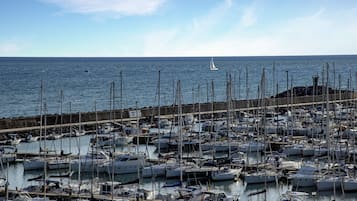 A marina filled with various boats docked at the pier.