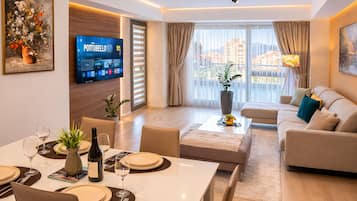 Comfort Condo, City View | Living room | TV