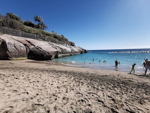 A beach with rocky formations and clear blue water. - Home2Book Amazing View Apartment Pool Adeje (Costa Adeje)