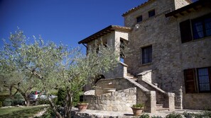 Step into a historic building with a rustic charm, featuring a grand staircase and beautifully maintained surroundings.