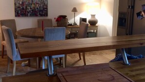 A dining area with a wooden table, chairs, a lamp, and a refrigerator. - Holiday home sleeps 6 central,  10 minute walk to golf course (Lahinch)