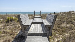 A wooden boardwalk leading to a beach with a clear view of the ocean. - Oceanfront, private pool,hot tub,elevator located in the Dolphin Ridge community (Emerald Isle)