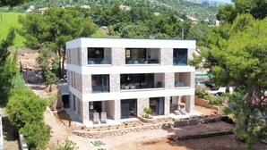 A modern two-story house with a stone facade, large windows, and a balcony. - Nautilus-Bay Suites - Apt. 420 Three-room suite for 2-6 persons (Zavala)