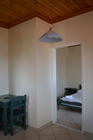 Cozy retreat with a single bed and compact table and chair.