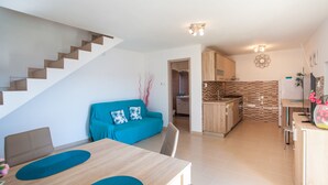 A modern apartment with a staircase, a dining area, a kitchen, and a living room. - Apartment Marija (Cres)