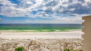 A beach with a wooden boardwalk leading to the shore, a sandy beach, and a clear view of the ocean. - Beach Service Included! Gulf-front, Okaloosa Island, Dune Point 701 (Fort Walton Beach)