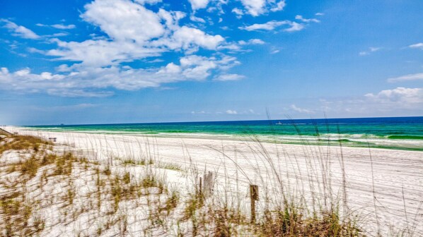 Enjoy a serene beach experience with calm seas and soft white sand.