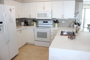 Enjoy cooking in this well-equipped kitchen with a stainless steel range, double oven, and microwave.