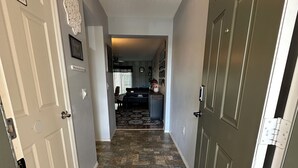A hallway with a patterned carpet, a powder room sign, and a ceiling light fixture. - Your Orlando theme park and shopping paradise!       Long term renters welcome (Kissimmee)