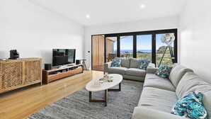 A modern living room with a television, sofa, and coffee table. - Point Break (Anglesea)