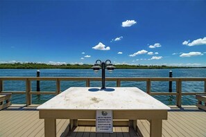 Enjoy a serene waterfront setting with a dock and picnic table.