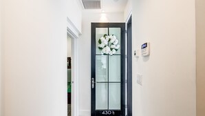 A modern hallway with a black door marked "430 1/2".