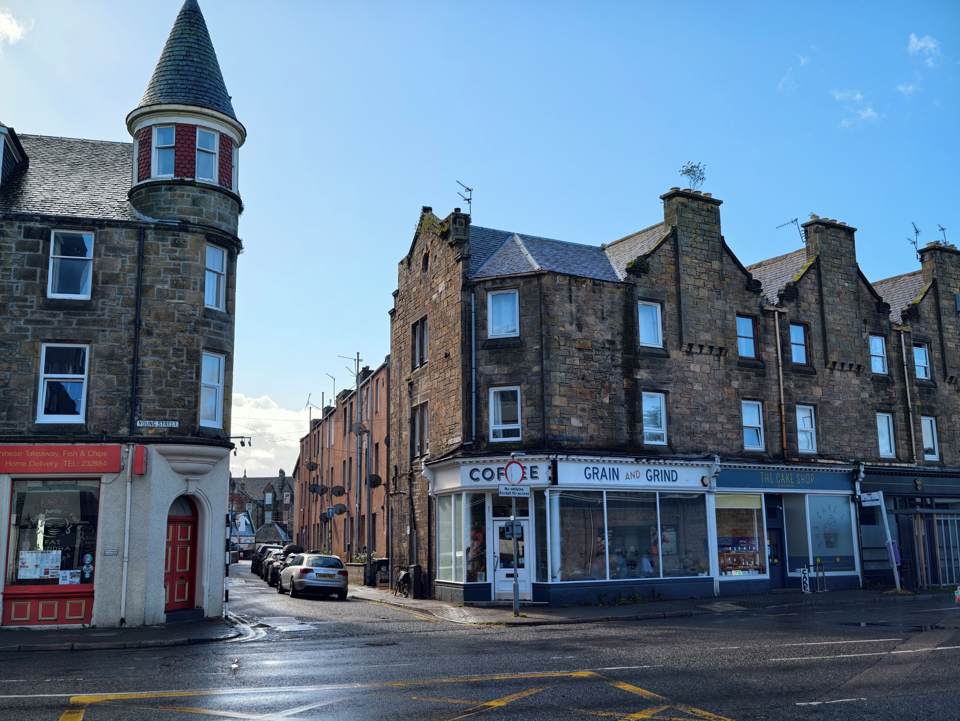 A street with buildings, including a bakery and a Chinese takeaway.