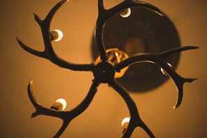 A chandelier with multiple arms and light bulbs. - STAG city centre studio apartment (Inverness)