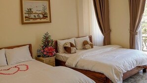 A hotel room with two beds, beige walls, a framed picture, and curtains. - Huong Anh Luxury Hotel Dalat (Lang Biang - Da Lat)