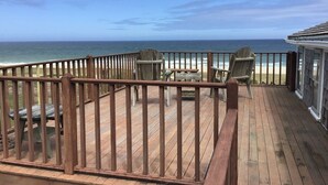 A wooden deck with a railing overlooking a beach. - Nauset Heights - The Ocean At Your Doorstep! (2127) (Orleans)