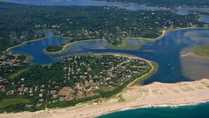An aerial view of a coastal area with a beach, a marina, and residential buildings. - Nauset Heights - The Ocean At Your Doorstep! (2127) (Orleans)