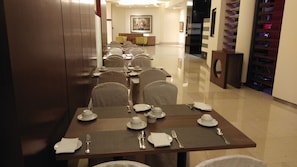 A dining area with tables set for service, a reception desk, and a staircase with a sign. - Times Square Residence At Kuala Lumpur (Kuala Lumpur)