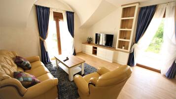Comfort Apartment, Sea View | Living area | 35-inch flat-screen TV with cable channels, TV