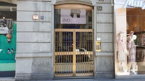 A storefront with a large glass window displaying mannequins in fashionable clothing. - Milano Dreams (Milan)