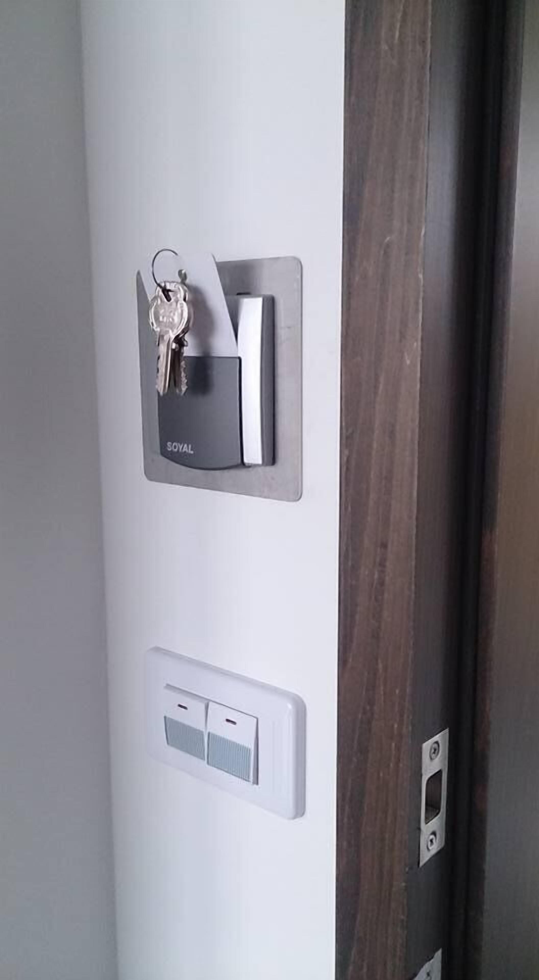 Uma porta com um porta-chaves rotulado "ROYAL" e um interruptor de luz.