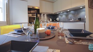 A modern kitchen with a dining area set for a meal.