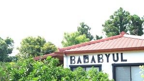 A building with the sign "BABABYUL" and a red-tiled roof.