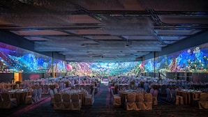 A banquet hall with round tables, chairs, and a central aisle. - Pullman Suzhou Zhonghui (Suzhou)