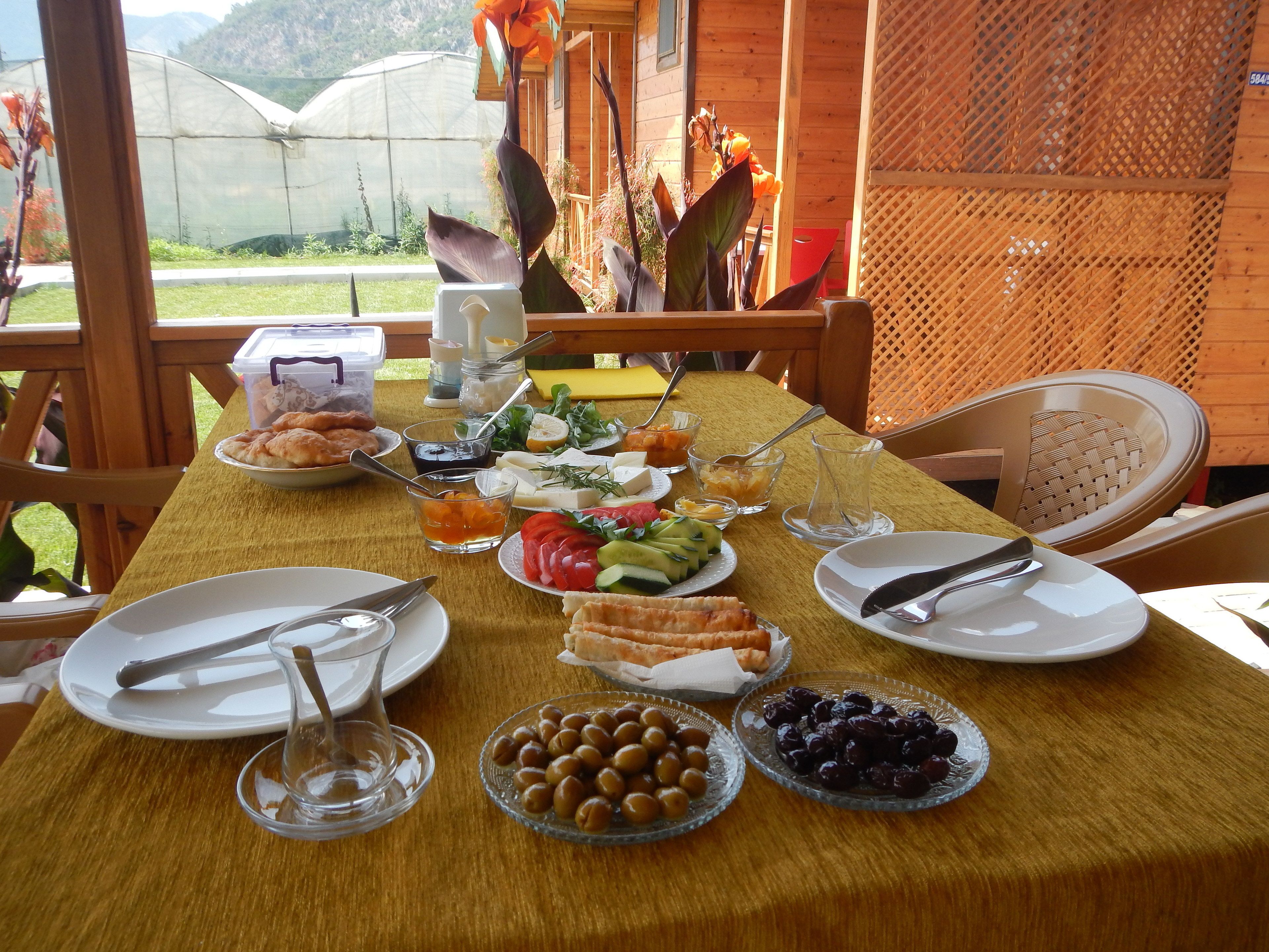 A table set for breakfast with various food items and drinks.