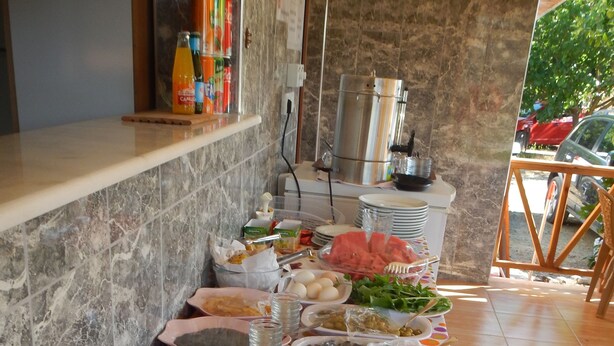 A buffet table with various food items and condiments.